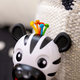 BABY EINSTEIN Kousátko s chrastítkem zebra Zen™ Shake-a-Shape 0m+